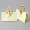 yellow paper bag, gift bag